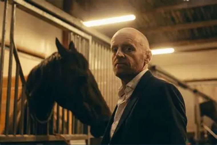 James Brannigan in a stable with a horse — connecting the equestrian world to the Trust's investigative and advocacy work